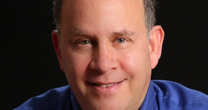 Smiling middle-aged man in blue shirt